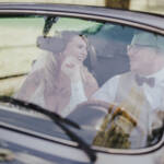 Brautpaar im Oldtimer lachend